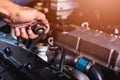 Hand of auto mechanic technician service check cooling water Royalty Free Stock Photo