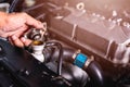 Hand of auto mechanic technician service check cooling water Royalty Free Stock Photo