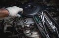 Hand of auto mechanic with a wrench.