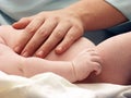 Hand on the baby's stomach Royalty Free Stock Photo