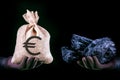Hand with bag with euro banknotes and hand with coal stone. Mining industry concept