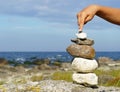 Hand balancing pile of stones