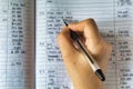 Hand and ballpoint pen on a ledger book, writing down expenses and calculating the taxes Royalty Free Stock Photo