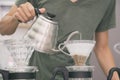 Hand of barista drip coffee, Barista pouring hot water on coffee ground with filter Royalty Free Stock Photo