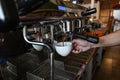 hand barista make coffee from professional machine, selective focus, beverage concept. Royalty Free Stock Photo