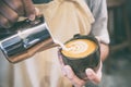 Hand of barista making latte or cappuccino coffee pouring milk making latte art Royalty Free Stock Photo