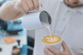 Hand barista pouring and serving cup of coffee