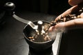 Hand pour coffee beans into grinder with smoke, on coffee drink maker concept Royalty Free Stock Photo