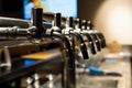 Hand of bartender pouring a large lager beer in tap. Rest in a bar with friends Royalty Free Stock Photo