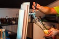 Hand of bartender pouring a large lager beer in tap Royalty Free Stock Photo