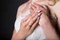Hand beautiful girl bride in white wedding dress with acrylic nails and delicate pattern and rhinestones Royalty Free Stock Photo