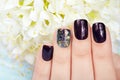 Hand with manicured nails colored with dark purple nail polish Royalty Free Stock Photo