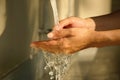 Hand of beauty woman  wash your hands at the wash basin with foam, cleanse the skin and have water flowing through the hands. Royalty Free Stock Photo