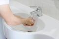 Hand of beauty woman  wash your hands at the wash basin with foam, cleanse the skin and have water flowing through the hands. Royalty Free Stock Photo