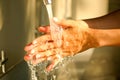 Hand of beauty woman  wash your hands at the wash basin with foam, cleanse the skin and have water flowing through the hands. Royalty Free Stock Photo