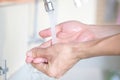 Hand of beauty woman  wash your hands at the wash basin with foam, cleanse the skin and have water flowing through the hands. Royalty Free Stock Photo