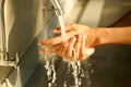 Hand of beauty woman  wash your hands at the wash basin with foam, cleanse the skin and have water flowing through the hands. Royalty Free Stock Photo