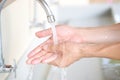 Hand of beauty woman  wash your hands at the wash basin with foam, cleanse the skin and have water flowing through the hands. Royalty Free Stock Photo