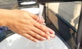 Hand of beauty woman  wash your hands at the wash basin with foam, cleanse the skin and have water flowing through the hands. Royalty Free Stock Photo