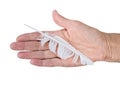 Hand with bedraggled white feather - cowardice or defeat concept.