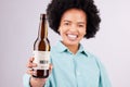 Hand, beer and advertising with a black woman in studio on a gray background for alcohol promotion. Portrait, bottle and