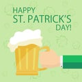 Hand with beer on Patricks day background