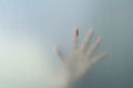 Hand behind frosted glass