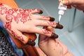 Hand being decorated with henna Royalty Free Stock Photo