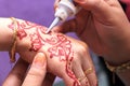 Hand being decorated with henna Royalty Free Stock Photo