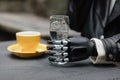 a hand with a bionic prosthesis holds a glass of water. a happy european cyber woman with a bionic prosthetic hand Royalty Free Stock Photo