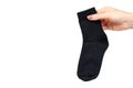 Hand with black cotton sock, foot clothing