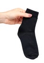 Hand with black cotton sock, foot clothing