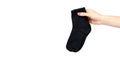 Hand with black cotton sock, foot clothing
