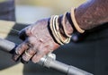 Hand of a black fisherman with homemade bracelets holding  fishing rod Royalty Free Stock Photo