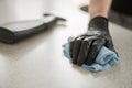 A hand in black gloves holds a microfiber cleaning cloth and a spray with sterilizing make disinfection for good hygiene Royalty Free Stock Photo