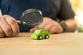 Hand with a black magnifying glass searching for a car to rent or buy. Choose a car Royalty Free Stock Photo