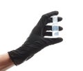 Hand in a black nitrile glove holds a plastic medical ampoule with medicine, isolated on white Royalty Free Stock Photo