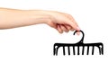 Hand with black plastic clothes hanger. Isolated background