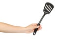 Hand with Black plastic kitchen spatula, kitchenware for cooking Royalty Free Stock Photo