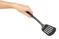 Hand with Black plastic kitchen spatula, kitchenware for cooking Royalty Free Stock Photo