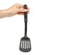 Hand with Black plastic kitchen spatula, kitchenware for cooking Royalty Free Stock Photo