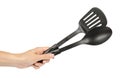 Hand with Black plastic kitchen spoon and spatula, kitchenware for cooking Royalty Free Stock Photo