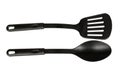 Hand with Black plastic kitchen spoon and spatula, kitchenware for cooking Royalty Free Stock Photo