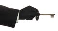 Hand with black rubber glove with old rusty key