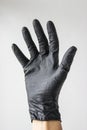 A man\'s hand in a black latex glove on a white background close-up. Royalty Free Stock Photo