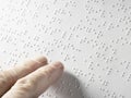Hand of a blind person reading some braille text touching the relief. Empty copy space for Editor Royalty Free Stock Photo