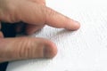 Hand of a blind person reading some braille text touching the relief. Empty copy space Royalty Free Stock Photo