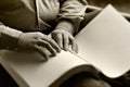 Hand of the blind reading a book Braille. Royalty Free Stock Photo
