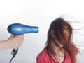 Hand with Blow Dyer Drying Long Hair of a Woman Royalty Free Stock Photo