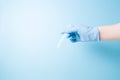 hand in blue disposable medical glove holds a glass empty test tube, Royalty Free Stock Photo